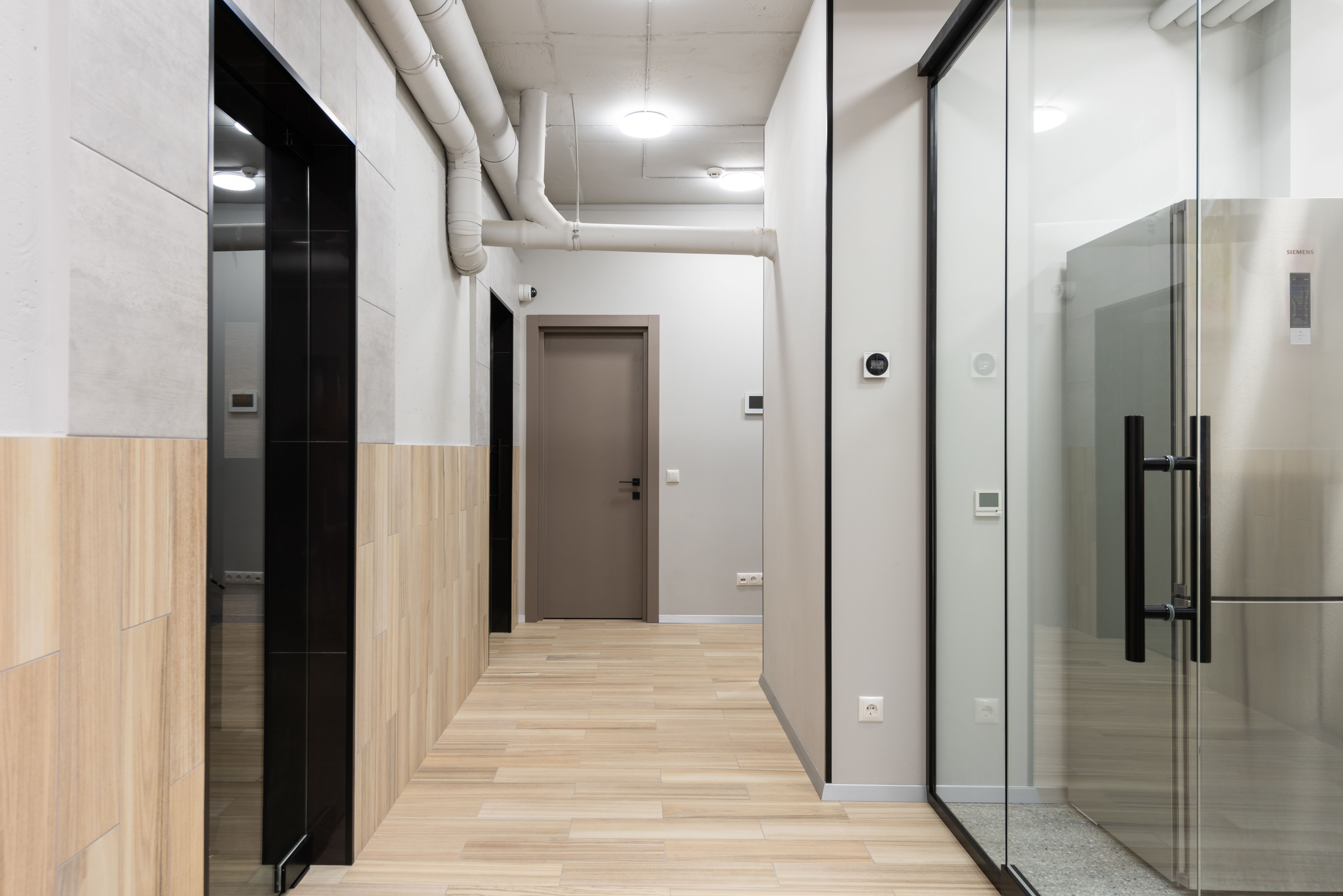 Bright commercial corridor with finished flooring and modern interior details.